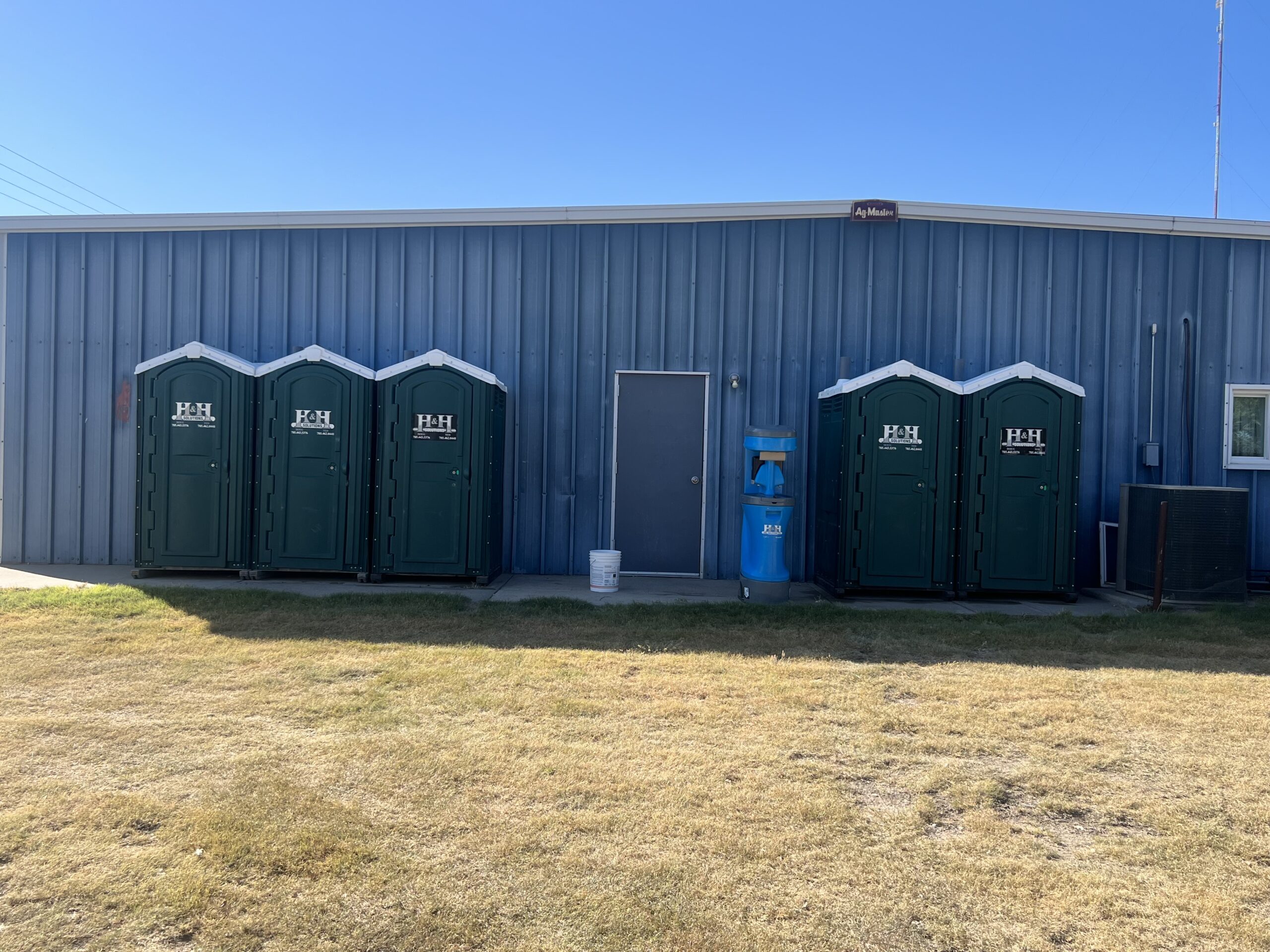 Green Toilet Rentals green toilet rentals in front of a blue building in western kansas