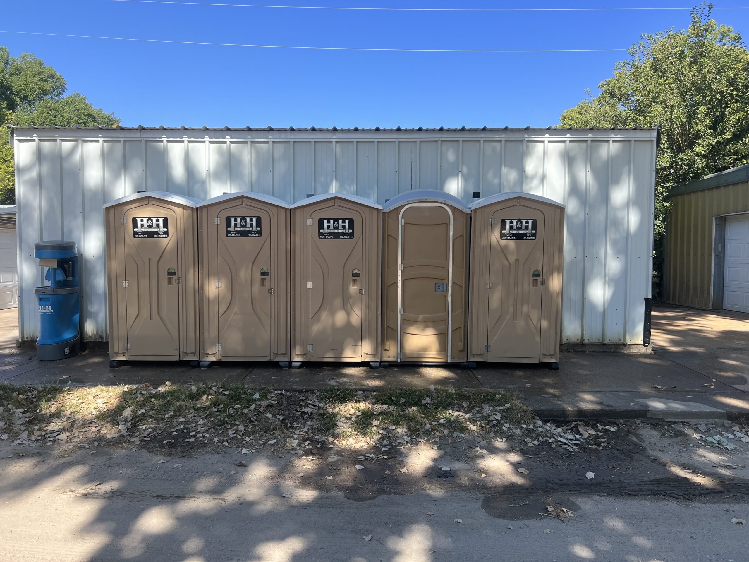 Tan Porta Pottys Tan Porta Pottys outside a building in Western Kansas